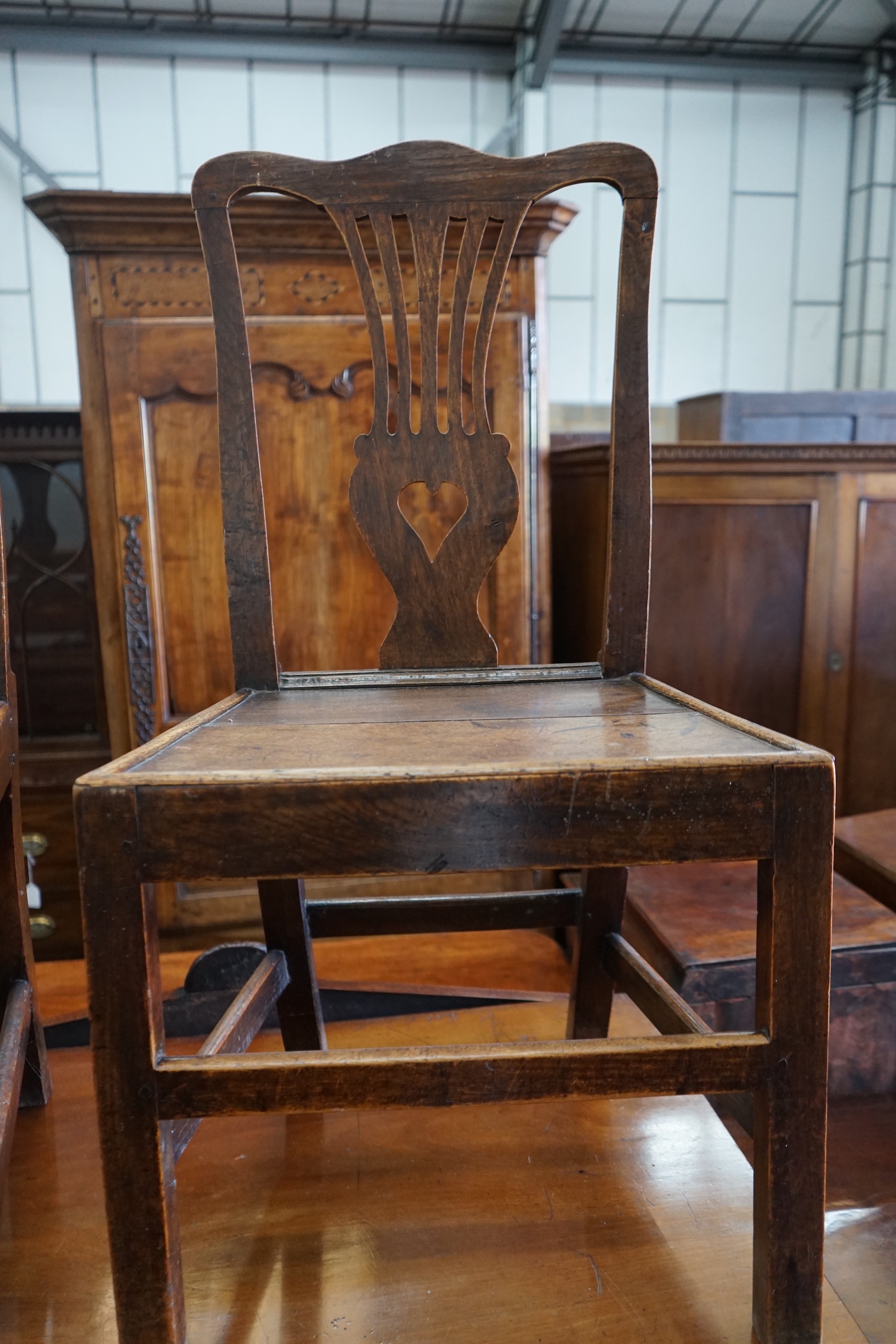 A George III oak open armchair and two similar side chairs